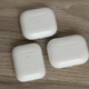 The third-gen AirPods charging case (top) compared to the second-gen charging case (bottom left) and the AirPods Pro charging case (bottom right).